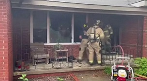 Firefighters at the house devastated by a fire caused by a dog chewing a lithium battery charger. Photo from Tulsa Fire Department.