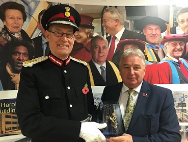 AvSax managing director Richard Bailey pictured receiving his Queen's Award for Enterprise from the Lord Lieutenant of West Yorkshire, Ed Anderson.